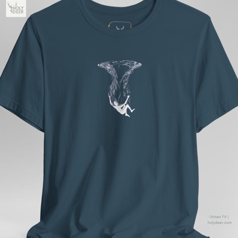 This surreal drowning top apparel in deep teal presents a professional and poetic look for freedivers, ocean lovers, and minimal graphic art collectors. HolyDeer emphasizes profound existential identity in this aesthetic teal shirt that fits perfectly in a modern wardrobe.