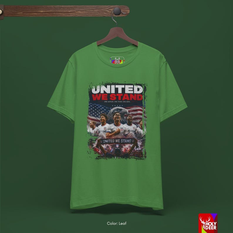 An artistic representation of the United We Stand shirt displayed on a minimalist hanger. The black color and detailed soccer art by HolyDeer create an emotional trigger for those seeking exclusive world cup gifts.