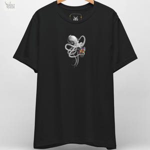 May include: Black t-shirt featuring a detailed illustration of a white octopus holding a colorful geometric shape. The shirt has a crew neck and short sleeves. The brand logo "HWD" is visible on the upper back.