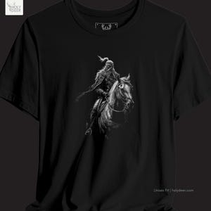 A person wearing a black nomad warrior shirt with a sharp, historic Turkic nomad top graphic on the front. The shirt represents a sophisticated epic rider top lifestyle and is part of the HolyDeer collection. Detailed view of the Attila the Hun shirt icons featuring the centered nomadic conqueror concept on a black base. This piece captures the soul of modern historical streetwear while maintaining a sophisticated apparel appeal.