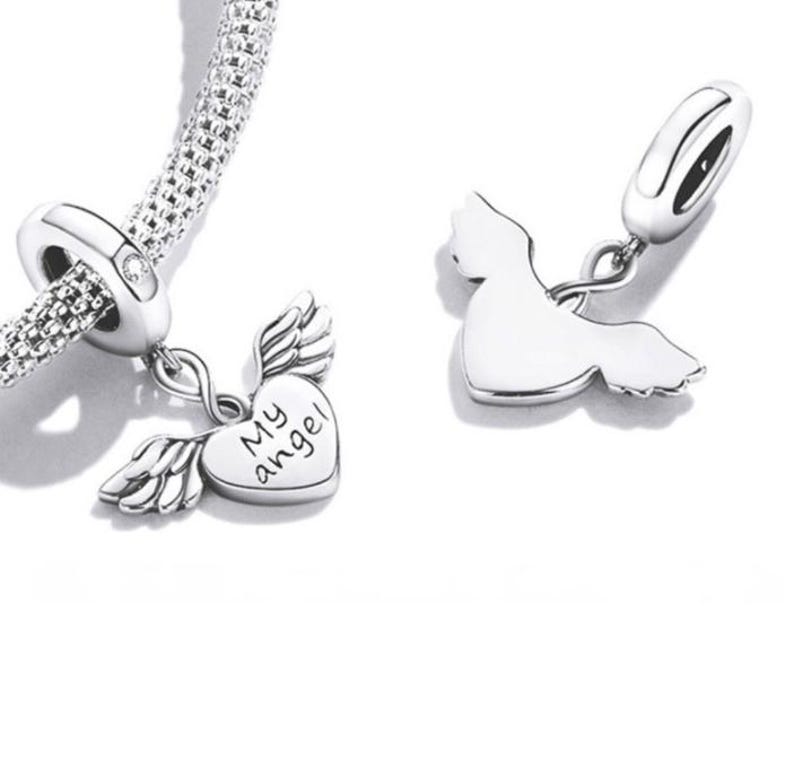 May include: Silver charm bracelet with two angel-themed charms. One charm is a heart with the words "My angel" and wings. The other charm is an angel silhouette. The bracelet has a textured, woven design.