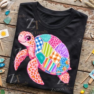 May include: A black t-shirt featuring a graphic of a pink sea turtle with a patchwork shell. The shell consists of various colorful patterns including plaid, stripes, leopard print, and floral designs. The text ZT Zynox Trends is visible.