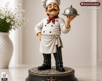 May include: A figurine of a chef wearing a white toque, a white double-breasted jacket with black buttons, a red neckerchief, and black pinstriped trousers. The chef holds a silver cloche on a tray, standing on a circular base with stone texture.