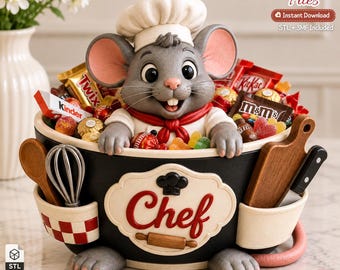 May include: A gray mouse wearing a white chef hat and red neckerchief sits inside a black bowl labeled "Chef" with a rolling pin graphic. The bowl contains various candies like Twix, KitKat, and M&Ms, and features side pockets holding a whisk and board.