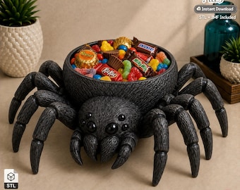 May include: A dark gray spider-shaped bowl with a textured surface and eight legs, filled with various colorful candies including KitKat, Snickers, and Reese's. The text 3D Printer Files Instant Download STL + 3MF Included is visible in the corner.