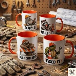 May include: Four white ceramic mugs with orange interiors and handles, each featuring a cartoon animal in a construction hat. The mugs display the text Sealed It, Nailed It, Built Different, and Fixed It alongside illustrations of a seal, raccoon, sloth, and turtle.