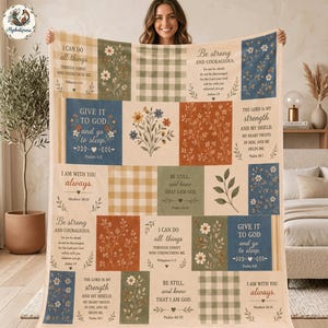 May include: A rectangular throw blanket featuring a patchwork design of various squares. The squares display floral patterns, green and tan gingham checks, and religious text including verses from Philippians, Joshua, Psalms, and Matthew.