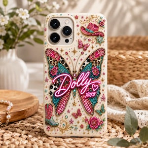 May include: A cream-colored phone case featuring a large central butterfly with teal, pink, and leopard print wings. The design includes a neon pink script reading Dolly xoxo, a pink cowboy hat, a teal cowboy boot, stars, and floral accents.