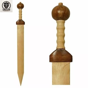 May include: A wooden sword featuring a light-coloured blade and a two-toned handle. The hilt consists of a dark brown crossguard, a light tan ribbed grip, and a rounded dark brown pommel. The design reflects a classic gladius style.