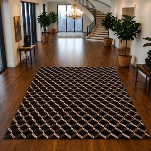 May include: A rectangular area rug featuring a repeating geometric pattern of black, white, and tan cubes. The rug is positioned on a dark wood floor in a large room with tall windows, potted plants, and a staircase in the background.