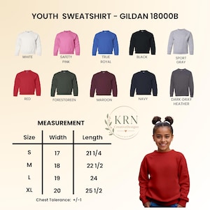 May include: A Gildan 18000B youth sweatshirt color chart featuring ten options: white, safety pink, true royal, black, sport gray, red, forest green, maroon, navy, and dark gray heather. Includes a size chart with width and length in inches.