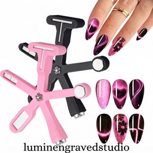 May include: A pink and a black multi-head magnetic nail art tool with flower-shaped centers, used to create cat-eye patterns on fingernails. The tool features various magnetic tips, and the image displays six almond-shaped nail samples with pink designs.