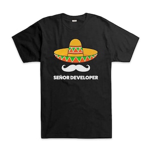 May include: Black t-shirt with a sombrero, white mustache, and the text "SEÑOR DEVELOPER". The sombrero is yellow with green and red detailing. A humorous design, perfect for developers with a sense of fun.