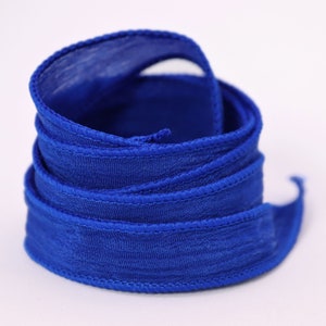 a close up of a blue ribbon on a white background