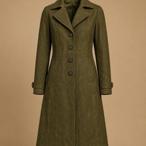 May include: Olive green long coat with a notched collar, button closure, and long sleeves. The coat features a tailored fit and a classic design, suitable for various occasions. The coat has a length that extends to the mid-calf.