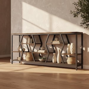May include: A modern, dark-framed shelving unit with geometric accents. The shelves are filled with decorative vases, books, and woven baskets. A potted olive tree stands to the right, adding a natural element to the room.