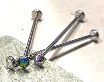 May include: Three silver barbell body jewelry pieces with clear, blue, and iridescent gem tops.