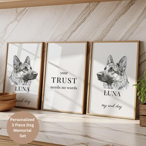 Könnte beinhalten: Ein dreiteiliges Wandbild-Set in hellen Holzrahmen. Zwei äußere Drucke zeigen eine schwarz-weiße Skizze eines Deutschen Schäferhundes mit dem Namen LUNA und dem Text my soul dog. Der mittlere Druck enthält den Text your TRUST needs no words.
