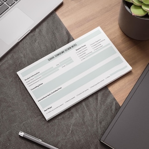 May include: A rectangular notepad titled School Counseling Session Notes with sections for student information, session focus, counseling notes, interventions used, and next steps. The white paper features black text and checkboxes for various categories.