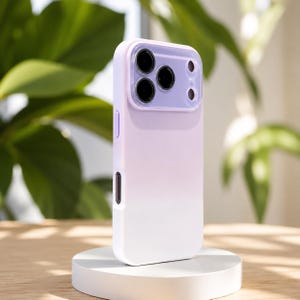 May include: A smartphone case featuring a smooth gradient design that transitions from a soft lavender purple at the top to a solid white at the bottom. The case includes a raised, integrated camera lens protector in a matching lavender shade.