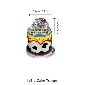 May include: A Toy Story themed cake topper featuring a group of animated characters and a blue banner with the text HAPPY BIRTHDAY. The topper measures 16.9 cm in width and 10.5 cm in height, displayed atop a cow-print decorated cake.