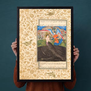 May include: A framed rectangular print featuring a central miniature painting of a winged figure interacting with a merman in a dark pool, surrounded by a cream-coloured border with gold floral patterns and Persian script text above and below.