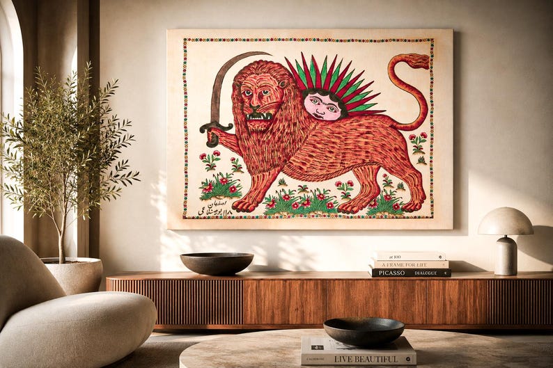 May include: A rectangular wall art print featuring a stylized red lion holding a curved sword. The lion has a human face emerging from its back surrounded by green rays. The artwork includes small floral motifs and Persian script text.