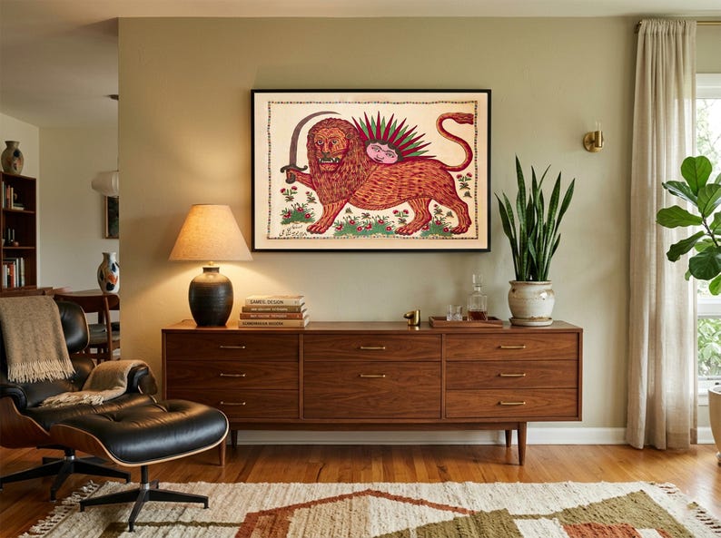 May include: A framed wall art print featuring a stylized illustration of a lion holding a curved sword, with a sun-like face on its back, set against a cream background with floral accents and a decorative border in a black frame.