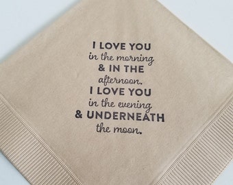 May include: A square, tan-colored paper napkin with a decorative border. The napkin features black text that reads, "I LOVE YOU in the morning & IN THE afternoon. I LOVE YOU in the evening & UNDERNEATH the moon."