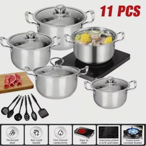 May include: A stainless steel 11-piece cookware set with glass lids. The set includes various sized pots and a selection of black cooking utensils. The image also shows a wooden cutting board with sliced meat and an induction cooktop.