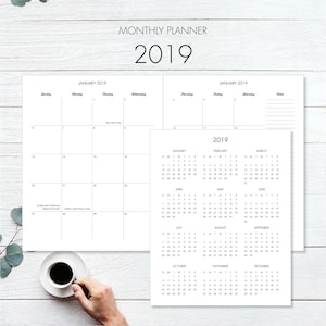 May include: A black and white monthly planner for the year 2019. The planner includes a calendar view for each month, with the days of the week labelled. The planner also includes a section for notes and to-do lists.