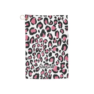 May include: A rectangular golf towel featuring a white background with a black and pink leopard print pattern. The word SheGolf is printed in black near the bottom center. A small gold-toned metal ring is attached to the top left corner.