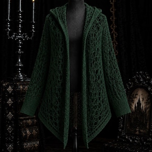 May include: A dark forest green open-front cardigan featuring a hooded design and an intricate, loose-knit crochet pattern throughout the body and sleeves, with solid ribbed cuffs and a solid ribbed hemline along the front edges.