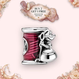 May include: A silver charm bead featuring a stylised mouse character holding a needle, positioned next to a cylindrical spool element with a deep red enamel finish. The charm includes the text BUY 2 GET 1 FREE MESSAGE FOR FREE PICKS.