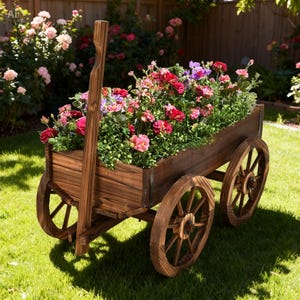 May include: A rustic wooden wagon planter filled with vibrant red, pink, and purple flowers. The wagon has large wooden wheels and a long handle, set on a green lawn with a garden backdrop.