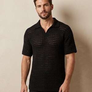 May include: Black polo shirt with a textured, open-knit design. The short-sleeved shirt features a collared neckline and a relaxed fit. The knit pattern creates a breathable, lightweight feel, suitable for warmer weather. The shirt is a solid black color.