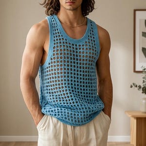 May include: A light blue, open-weave tank top. The sleeveless top has a round neckline and a loose fit. The model is wearing the tank top with light-coloured trousers. The tank top is a stylish and breathable garment.