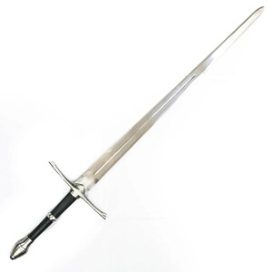 May include: A long sword featuring a polished silver-toned steel blade with a central fuller. The hilt consists of a black cylindrical grip, a straight silver crossguard with tapered ends, and a smooth, rounded silver pommel at the base.