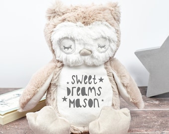 May include: A plush brown owl with white accents and closed eyes. The owl is sitting on a wooden surface and has the text "Sweet Dreams Mason" embroidered on its chest.