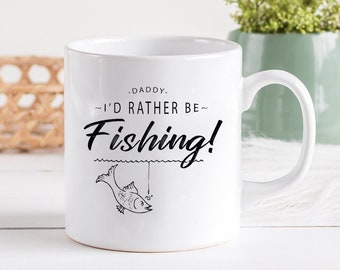 May include: White ceramic coffee mug with a black graphic that says "Daddy - I'd rather be fishing!" with a cartoon fish and fishing line.