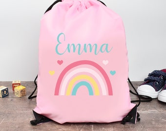 May include: Pink drawstring bag with a rainbow and hearts design. The bag is personalized with the name "Emma".