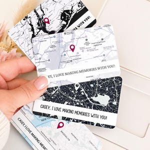 May include: Four personalized map cards with a white background and black city map designs. Each card features a red location marker and the text "Casey, I love making memories with you!" or "Hey, I love making memories with you!"