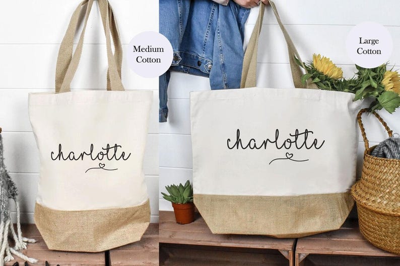 May include: Two tote bags with the name "charlotte" written in cursive with a small heart symbol. The smaller bag is labeled "Medium Cotton" and the larger bag is labeled "Large Cotton".