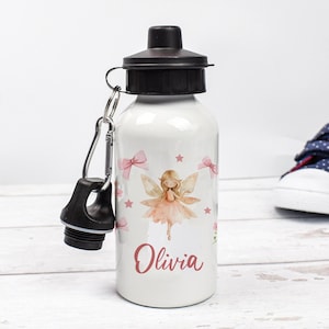 May include: White aluminum water bottle with a pink fairy design, pink bows, and stars. The bottle has a black lid and a black carrying handle. The name "Olivia" is printed on the bottle.