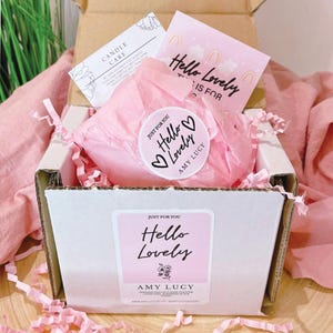 May include: A white box with pink tissue paper inside. The box has a sticker on the front that says "Just for you! Hello Lovely Amy Lucy".