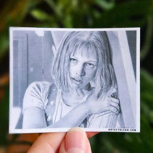 May include: A rectangular sticker featuring a black and white graphite-style illustration of a person with shoulder-length hair and a collared shirt. The text ARTSYTALEAN.COM is printed in the bottom right corner of the sticker's white border.