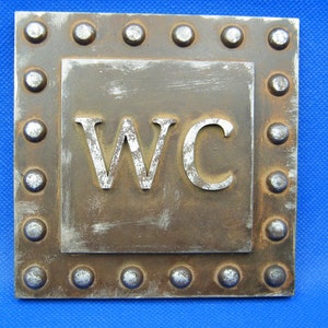 Antique stile , rusted iron with rivets stile - WC - toilet sign