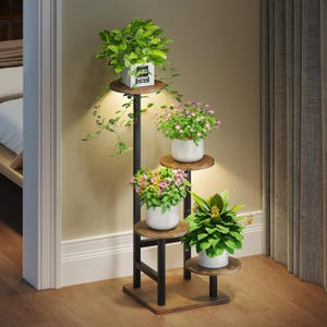May include: A multi-tiered plant stand featuring a black metal frame and circular wooden shelves. The stand holds five potted plants with green foliage and colorful flowers, arranged at varying heights on the tiered structure.