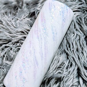 May include: White tumbler with a swirl pattern and iridescent glitter.