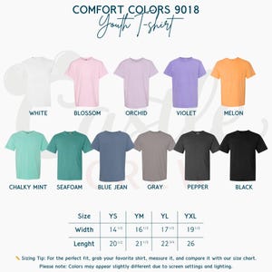 May include: A display of Comfort Colors 9018 youth t-shirts in various colors, including white, pink, purple, orange, and green. The image also shows a size chart with measurements in inches for width and length. The text reads "Youth T-shirt."